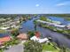 Breathtaking aerial view of a home nestled along the waterfront, surrounded by lush greenery and serene waterways at 1461 Marlin St, Nokomis, FL 34275