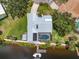 A beautiful waterfront property showcases a private pool, dock, with easy access to water activities, and lush green landscaping at 1461 Marlin St, Nokomis, FL 34275