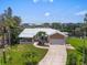 Stunning aerial view of a waterfront residence with a private dock and lush landscaping in a serene setting at 1461 Marlin St, Nokomis, FL 34275