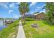 Captivating waterfront home featuring a private dock, fire pit, and lush landscaping, perfect for outdoor enjoyment at 1461 Marlin St, Nokomis, FL 34275