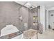 A modern bathroom featuring a glass-enclosed shower and a stylish bathtub with tile surround at 1461 Marlin St, Nokomis, FL 34275