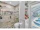 Beautiful bathroom featuring a glass shower, stone floors, and built-in shelving for towels and toiletries at 1461 Marlin St, Nokomis, FL 34275