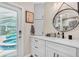 Stylish bathroom with double sink vanity, modern fixtures, with pool access and decor at 1461 Marlin St, Nokomis, FL 34275