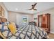 Comfortable bedroom with wood-look floors, ceiling fan, and sliding glass doors to the pool at 1461 Marlin St, Nokomis, FL 34275