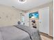 Neutral-toned bedroom with TV and sporty helmet at 1461 Marlin St, Nokomis, FL 34275
