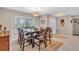 Traditional dining room area with large windows, stylish lighting, and a dining table for hosting gatherings at 1461 Marlin St, Nokomis, FL 34275