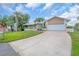 Inviting home features a long driveway, two-car garage, covered porch, and nicely maintained yard at 1461 Marlin St, Nokomis, FL 34275