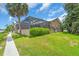 Inviting exterior view featuring a screened lanai and lush landscaping creating a relaxing outdoor space at 1461 Marlin St, Nokomis, FL 34275