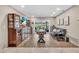Well-lit game room with a shuffleboard table and waterfront access with sliding glass doors to the outside at 1461 Marlin St, Nokomis, FL 34275