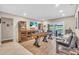 Spacious game room with a shuffleboard table and large sliding glass doors leading to the outdoor space at 1461 Marlin St, Nokomis, FL 34275