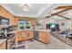 Open kitchen with light wood cabinets, stainless steel appliances, and open to the living room at 1461 Marlin St, Nokomis, FL 34275