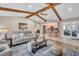 Cozy living room with wood beams, modern furniture, and easy access to the kitchen and sliding door access at 1461 Marlin St, Nokomis, FL 34275