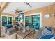 Cozy screened-in patio with comfortable seating, ceiling fan, and views of the pool area at 1461 Marlin St, Nokomis, FL 34275