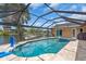 Inviting screened-in pool and spa with waterfront views, boat dock, and recreational features at 1461 Marlin St, Nokomis, FL 34275