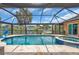 Sparkling screened-in pool and spa overlooking the waterfront with tile surround and metal framework at 1461 Marlin St, Nokomis, FL 34275