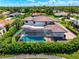 Aerial view of a home with a screened-in pool and a well maintained lawn at 1484 Seafarer Dr, Osprey, FL 34229