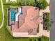 Aerial view of a home featuring a tile roof and a screened-in pool area at 1484 Seafarer Dr, Osprey, FL 34229