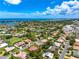 Aerial view of a home within a Sarasota community offering water access, lush lawns, and mature trees at 1484 Seafarer Dr, Osprey, FL 34229