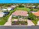Beautiful home with well-manicured lawn, a circular driveway, and lush tropical landscaping at 1484 Seafarer Dr, Osprey, FL 34229