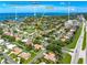 Aerial view of a residential neighborhood showcasing well-manicured lawns and nearby Sarasota Bay at 1484 Seafarer Dr, Osprey, FL 34229