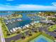 Stunning aerial view of the community marina with boats docked, clubhouse, tennis court, and beautiful waterfront homes at 1484 Seafarer Dr, Osprey, FL 34229