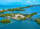 Stunning coastal view featuring turquoise waters and lush islands with beautiful homes at 1484 Seafarer Dr, Osprey, FL 34229