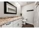 Cozy bathroom features granite vanity with black accents and a patterned shower curtain creating a functional space at 1484 Seafarer Dr, Osprey, FL 34229