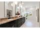 Spacious bathroom with dual sinks, granite countertop, large mirrors and modern fixtures at 1484 Seafarer Dr, Osprey, FL 34229