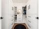 Custom walk-in closet with white cabinets, drawers, and ample storage space at 1484 Seafarer Dr, Osprey, FL 34229