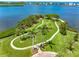 Aerial view of waterfront community park with a walking path and lush landscaping at 1484 Seafarer Dr, Osprey, FL 34229
