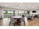 Bright dining area with multiple tables, chairs, and large windows providing beautiful views of the water at 1484 Seafarer Dr, Osprey, FL 34229