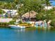 Charming dockside bar with thatched roof offering a relaxed waterfront experience at 1484 Seafarer Dr, Osprey, FL 34229
