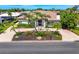Elegant home featuring a red tile roof, lush landscaping, and a brick-paved driveway, offering curb appeal at 1484 Seafarer Dr, Osprey, FL 34229