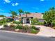 Beautiful front of house with tropical landscaping and a brick paver circular driveway at 1484 Seafarer Dr, Osprey, FL 34229
