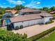 Aerial view of house with a three car garage and a screened-in pool at 1484 Seafarer Dr, Osprey, FL 34229