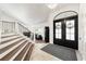 Inviting foyer featuring a wood-accented staircase and elegant decor leading to a cozy living space at 1484 Seafarer Dr, Osprey, FL 34229