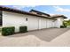 Spacious three-car garage with an extended brick-paved driveway, nestled amongst neatly trimmed shrubs at 1484 Seafarer Dr, Osprey, FL 34229