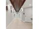Bright hallway with wood ceiling accents, modern fixtures, and clean design, leading to the community restrooms at 1484 Seafarer Dr, Osprey, FL 34229