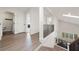 Hallway featuring wood floors, white walls, and staircase leading to the living room with natural light streaming in at 1484 Seafarer Dr, Osprey, FL 34229