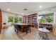 Inviting library featuring ample seating, bookshelves filled with books, and a bright window overlooking the community at 1484 Seafarer Dr, Osprey, FL 34229
