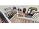 Bright living room showcasing a fireplace, plush seating, plantation shutters, and a staircase leading to a welcoming entry at 1484 Seafarer Dr, Osprey, FL 34229