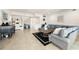 Open living area with tile floors, a large sectional sofa, and stylish furnishings at 1484 Seafarer Dr, Osprey, FL 34229
