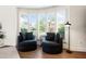 Charming sitting area with plush chairs and large windows showcasing a lush view at 1484 Seafarer Dr, Osprey, FL 34229