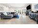 Spacious living area with stylish decor, fireplace, and views of the pool area at 1484 Seafarer Dr, Osprey, FL 34229