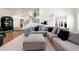 Stylish living room with a large sectional, modern decor, and open access to a staircase, perfect for entertaining guests at 1484 Seafarer Dr, Osprey, FL 34229