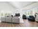 Bright living room boasts a fireplace, vaulted ceilings, wood floors and large windows with beautiful shutters at 1484 Seafarer Dr, Osprey, FL 34229