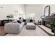 Elegant living room with a modern fireplace, sleek furniture, and plenty of natural light, creating a warm atmosphere at 1484 Seafarer Dr, Osprey, FL 34229