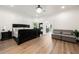 Large bedroom with hard wood floors, a dark bed frame, and sitting area at 1484 Seafarer Dr, Osprey, FL 34229