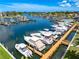Picturesque marina view, showcasing boats docked at slips with clear blue water and lush landscaping around the harbor at 1484 Seafarer Dr, Osprey, FL 34229