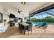 The outdoor patio boasts a built-in grill, dining table, and lounge chairs alongside the sparkling pool at 1484 Seafarer Dr, Osprey, FL 34229